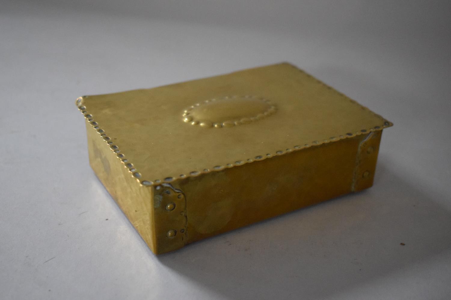 An Early 20th Century Hand Beaten Brass Cigarette Box with Banded Rivet Decoration, Makers Stamp