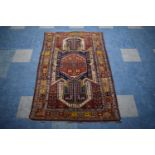 An Antique Hand-Made Kazak Rug, 172 x 112cms