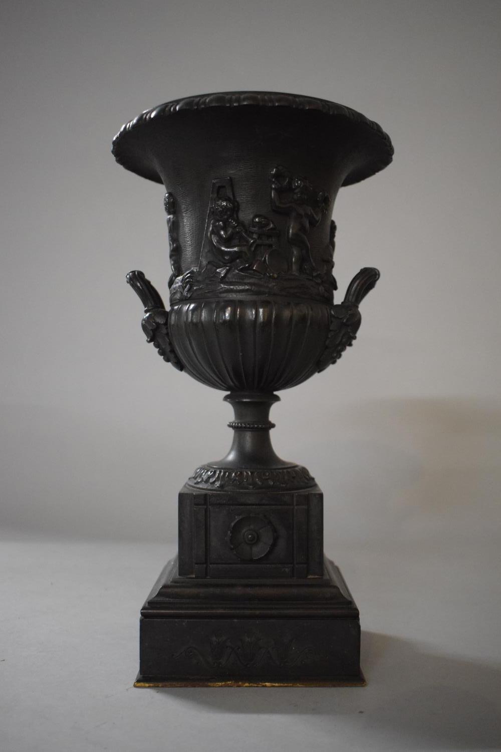 A 19th Century Cast Bronze Two Handled Urn with Flared Rim and Relief Decoration Depicting Pan