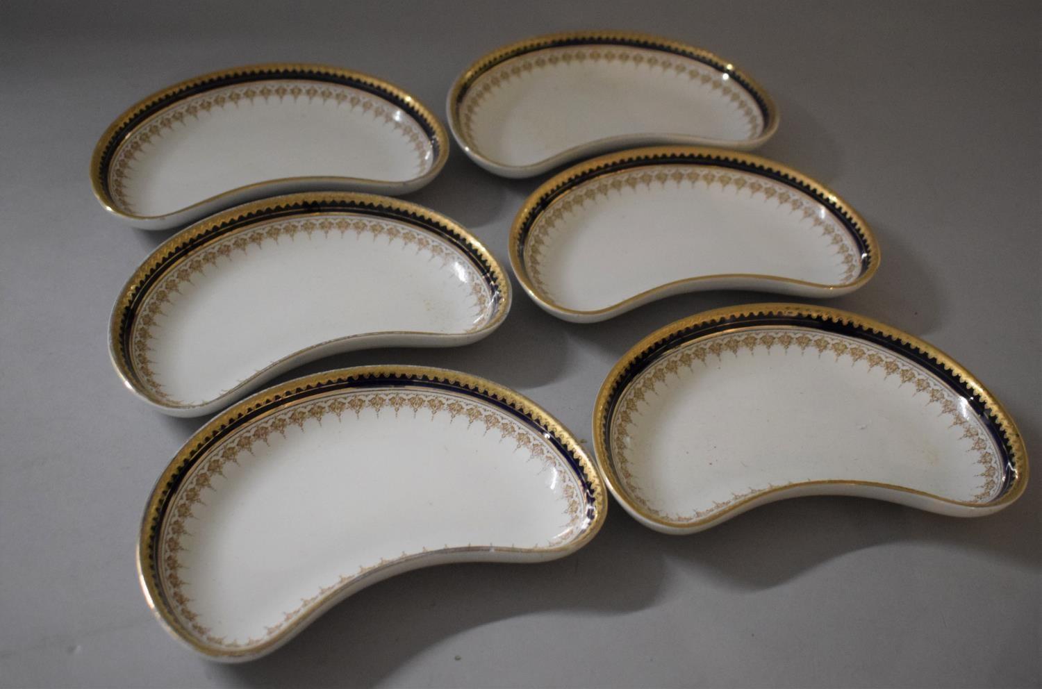 A Set of Six Booths Gilt and Blue Bordered Kidney Shaped Dishes