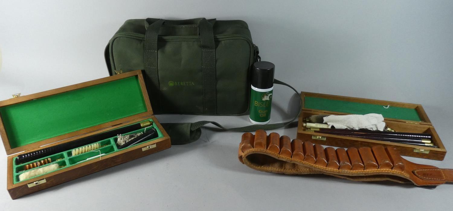 A Beretta Canvas Cartridge Bag, Two Gun Cleaning Kits and a Leather Cartridge Belt