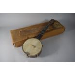 An Early 20th Century Four String Banjo Ukulele in Cardboard Box