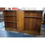 An Edwardian Oak Double Bookcase with Centre Cupboard, Plinth Base, 213 x 35 x 122cms High