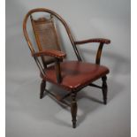 An Edwardian Hoop Back Armchair with Cane Back Panel and Leather Seat and Arms