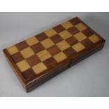 A Late 19th/ Early 20th Century Inlaid Mahogany Folding Chess Board Containing Various Draughts