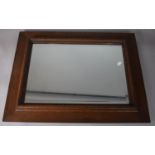 An Oak Framed Wall Mirror with Bevelled Glass, 72 x 56cms