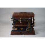 A Vintage Oak Cased Manual Sewing Machine by Wheeler & Wilson