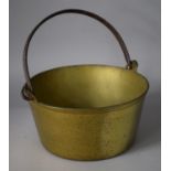 A Heavy Brass Jam Pan with Iron Loop Handle, 33cms Diameter