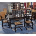 A Mid 20th Century Oak Draw Leaf Refectory Dining Table with Six Chairs Including Two Carvers