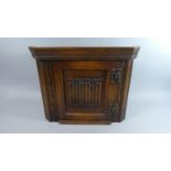 A Small Oak Wall Mounting Linenfold Corner Cabinet, 46cms Wide and 39cms High