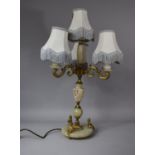 A Mid/Late 20th Century French Onyx and Gilt Metal Four Branch Table Lamp with Cherub and Scroll