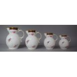 A Graduated Set of Four Coalport Mask Head Jugs