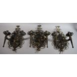 Three Wrought Iron Two Branch Wall Lights of Heraldic Form, 38cms High