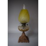 A Victorian Iron Based Oil Lamp with Yellow Glass Shade and Glass Reservoir