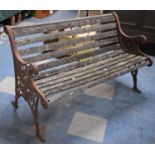 A Brown Painted Cast Iron Ended Garden Bench, 128cms Wide