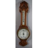 An Edwardian Carved Oak Aneroid Wheel Barometer with Thermometer, 84cms High
