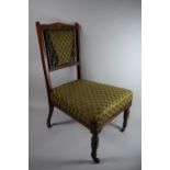 An Edwardian Inlaid Rosewood Nursing Chair with Upholstered Seat and Backrest
