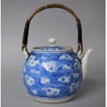 A Late 19th/Early 20th Century Japanese Prunus Pattern Teapot with Wicker Handle, 10cms High