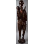 A Large Modern Carved Wooden African Figure of Huntsman with Bow Carrying Antelope, 98cms High
