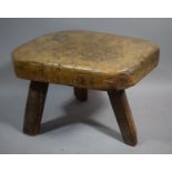 An Early 19th Century Heavy Elm Topped Three Legged Pig Bench Stool, 55cms Long