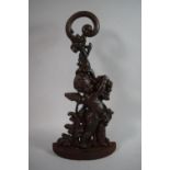 A 19th Century Cast Iron Door Porter in the Form of Cherub with Grapes, 43cms High
