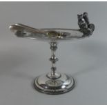 A Silver Plated Circular Nut Stand with Squirrel Mount and a Pair of Nutcrackers