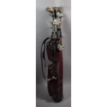 A Collection of Vintage Golf Clubs and a Golf Bag