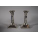 A Near Pair of Silver Corinthian Column Candlesticks on Stepped Square Bases (Filled), One Inscribed