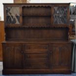 An Oak Linenfold Dresser with Three Centre Drawers and Raised Plate Rack with Leaded Glazed