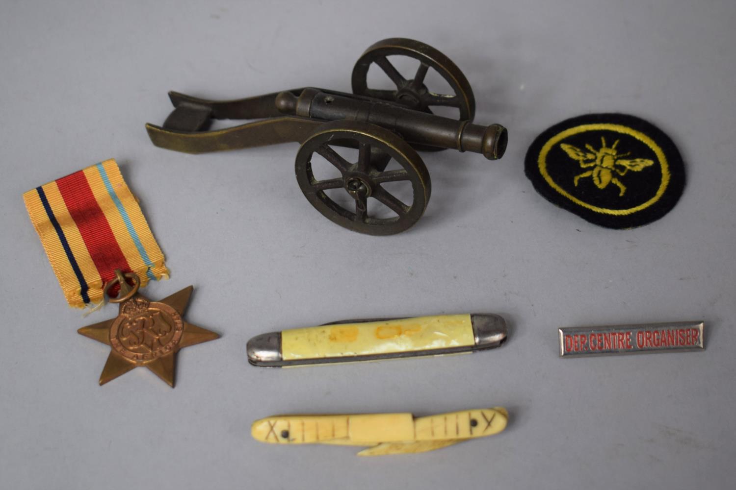 A Small Bronze Medal of a Cannon, A WWII Africa Star, Vintage Penknife, 19th Century Prisoner of War