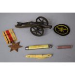 A Small Bronze Medal of a Cannon, A WWII Africa Star, Vintage Penknife, 19th Century Prisoner of War