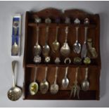 A Collection of Various Enamelled and Other Souvenir Spoons in Wooden Rack