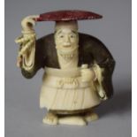 An Early 20th Century Japanese Carved Netsuke in the Form of Hatted Gent, Decorated with