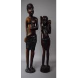 Two Large Carved African Tribal Figural Ornaments Depicting Female and Boy Carrying Game, 56cm High