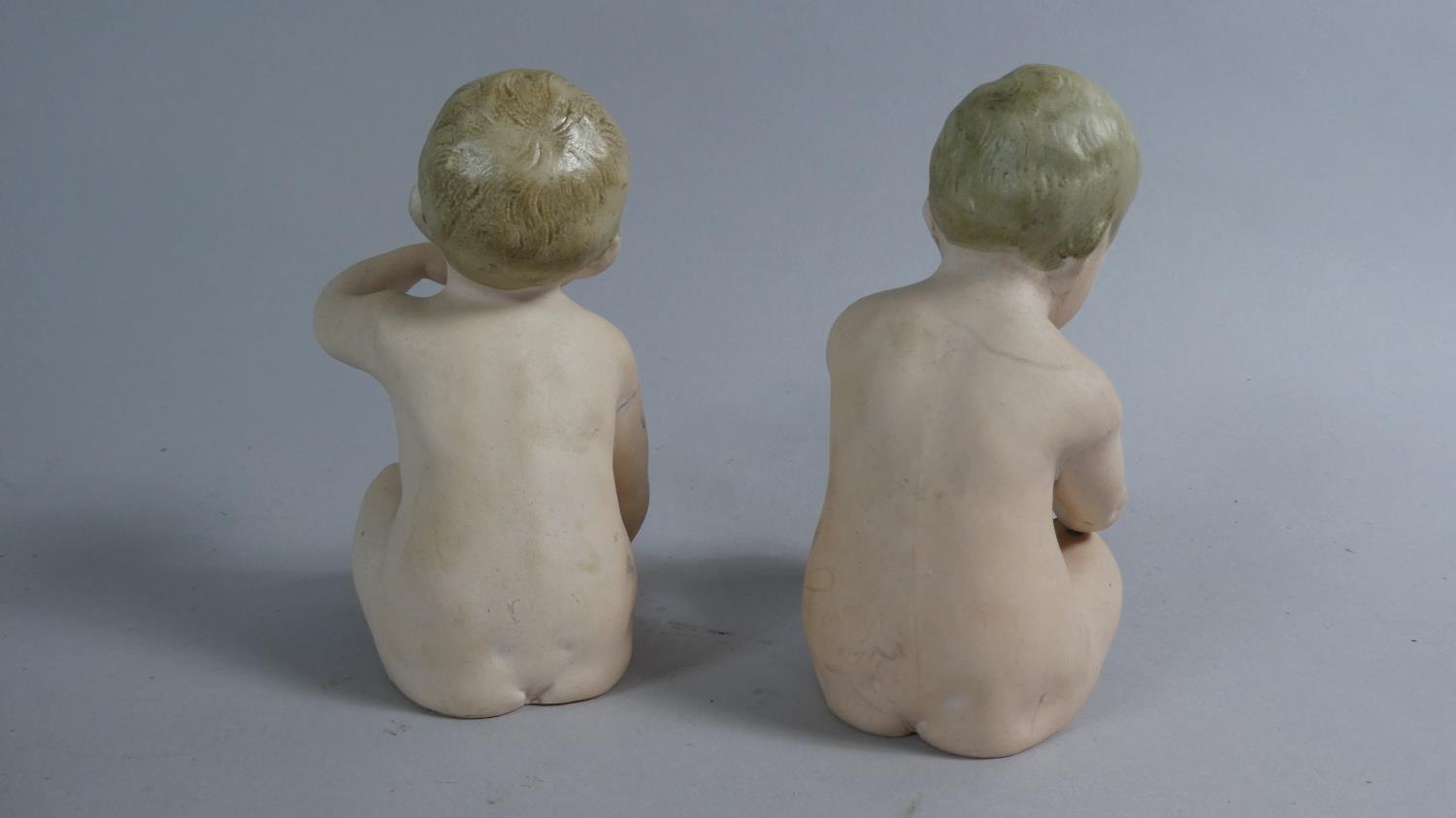 A Pair of Continental Bisque Porcelain Nude Piano Babies, 10cm High - Image 2 of 4