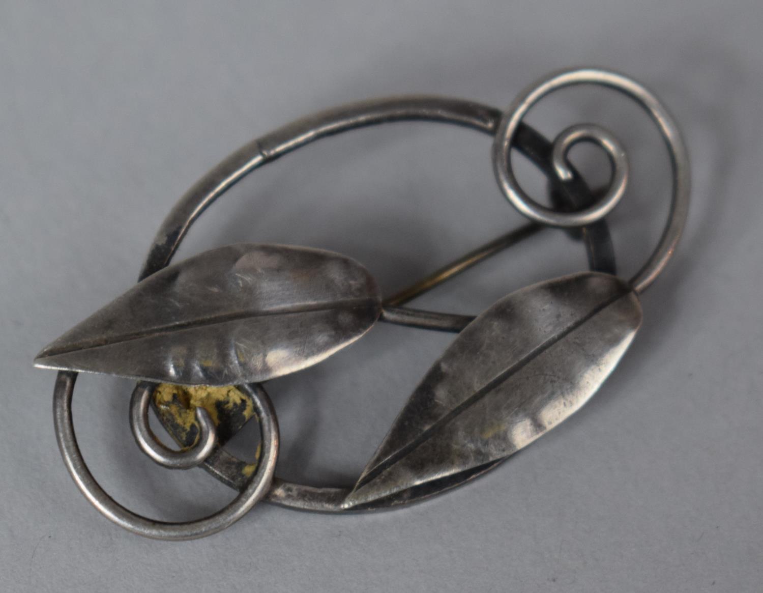 An Early 20th Century Silver Brooch in the Form of Leaves and Scrolls with Arts and Crafts