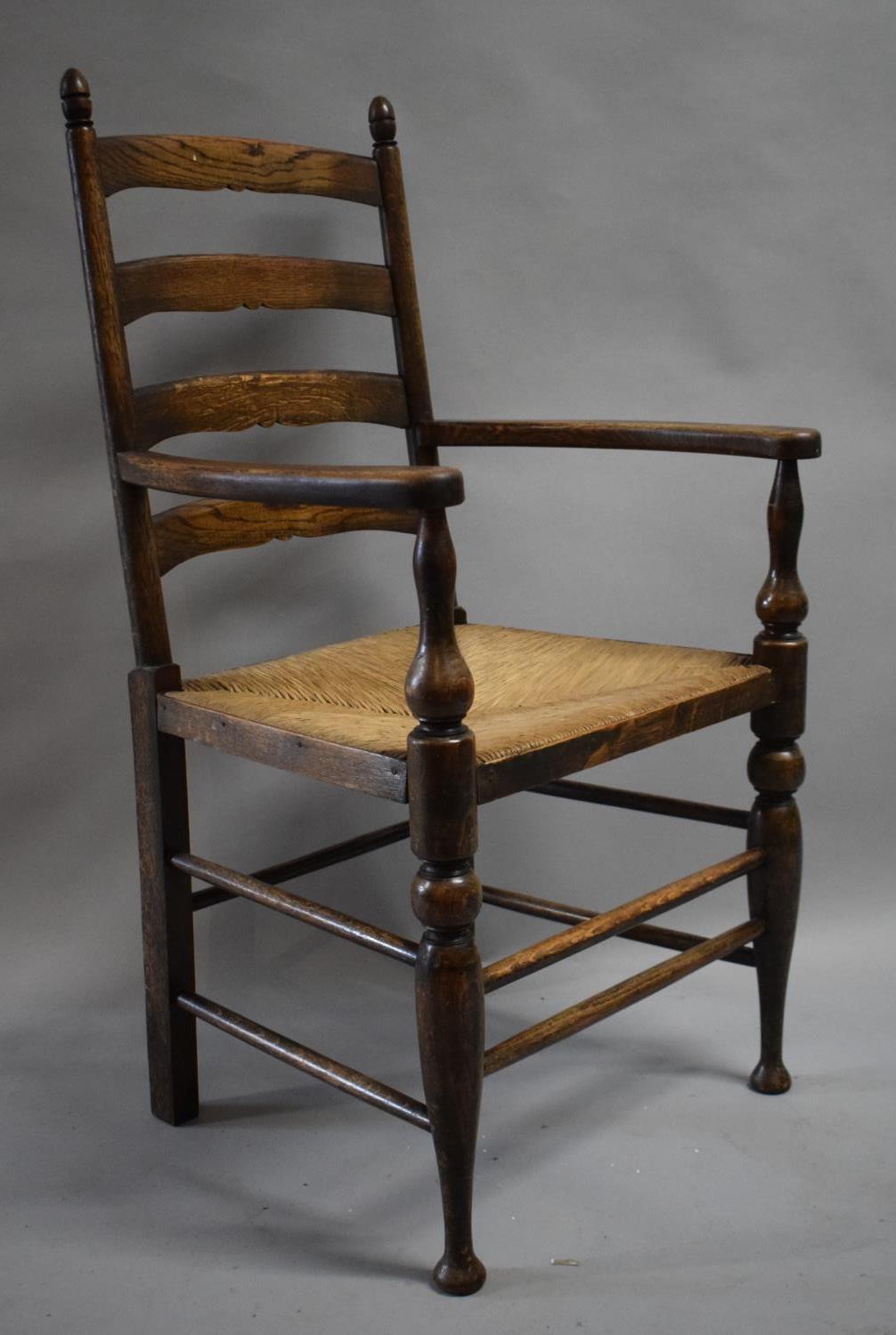 A Rush Seated Oak Framed Ladder Back Armchair with Brass Commemorative Plaque, "In Remembrance of