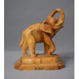 A Hand Carved Olivart Study of Elephant with Trunk in a Salute, 15cm high