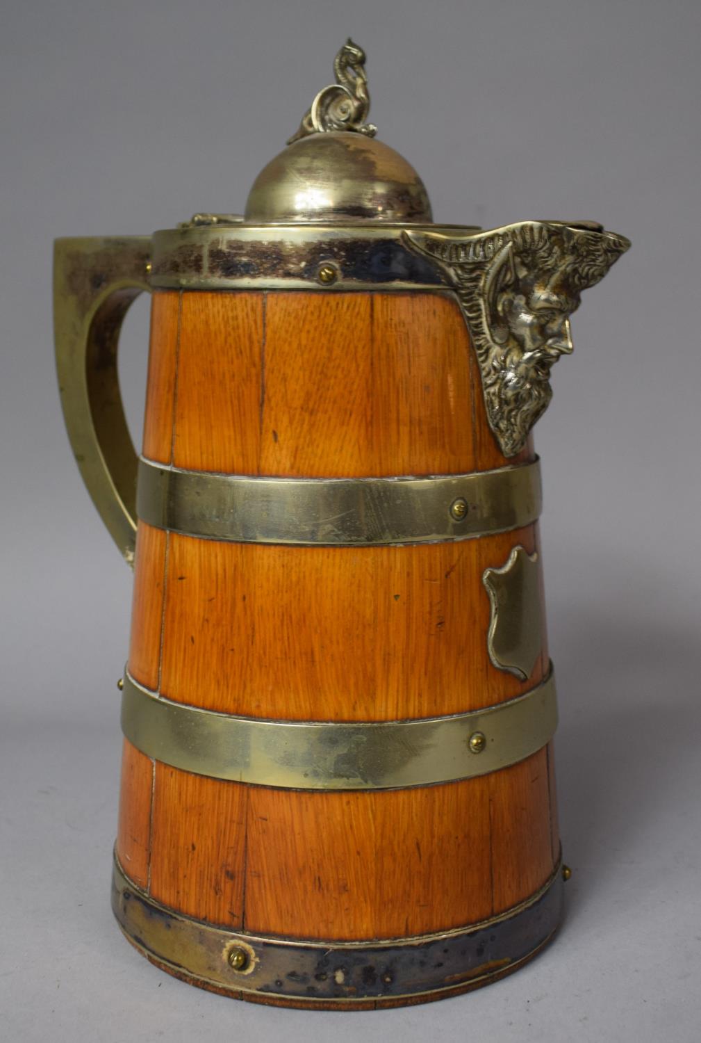 A Silver Plate Banded Oak Mask Head Lidded Jug with Ceramic Inner, 25cm High