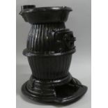 A Black Painted Cast Metal Stove, 53cm high