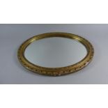 An Edwardian Pierced and Gilt Framed Oval Wall Mirror, 46cm Wide