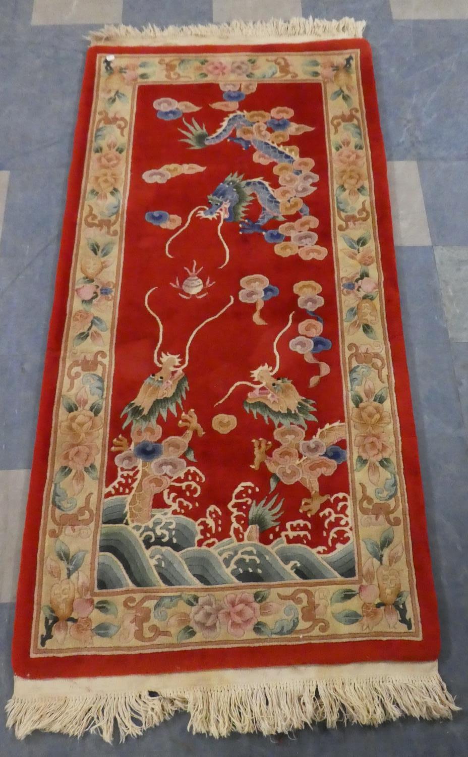 A Chinese Woollen Rectangular 'Dragon' Rug on Red Ground, 200 x 91cm