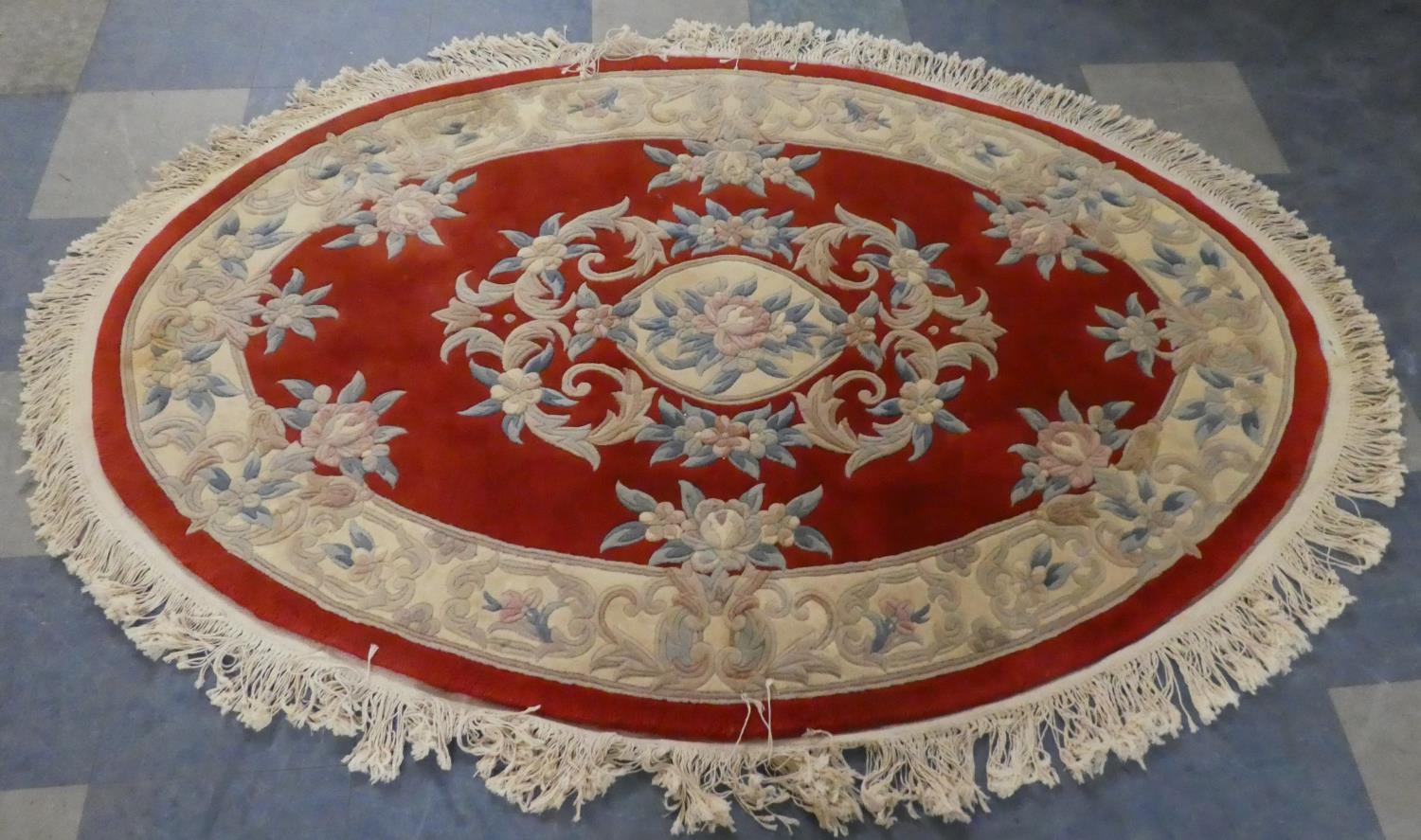 A Oval Chinese Woollen Rug on Red Ground, 185cm x 125cm