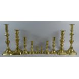 A Collection of Five Pairs of Late 19th/Early 20th Century Brass Candlesticks with Pushers, The