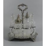 A Late Victorian/Edwardian Six Bottle Silver Plate and Glass Cruet Set on Stand with Scrolled