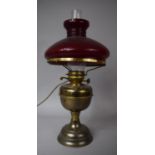 An Early 20th Century Oil Lamp Converted to Electric Table Lamp with Red Opaque Glass Shade, 49cm
