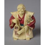 An Early 20th Century Japanese Carved Netsuke in the Form of a Robed Master with Bucket in Hand