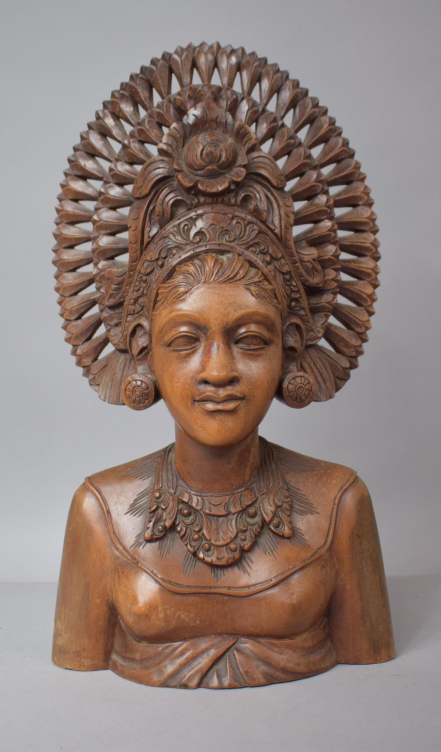 A Balinese Carved Teak Bust of Goddess with Headdress, 35cm high