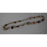 A White Metal and Semi Precious Stone Bracelet to include Citrine, Peridot and Garnet etc