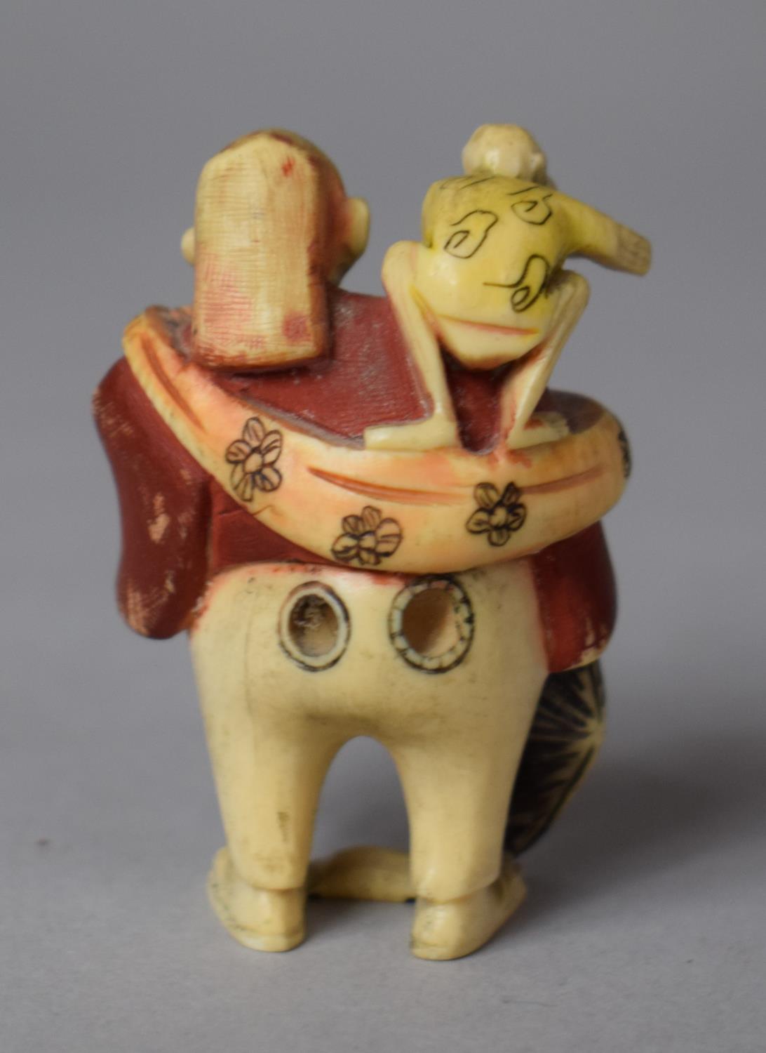 An Early 20th Century Japanese Carved Netsuke in the Form of a Trader with Monkey on Shoulder - Image 2 of 3